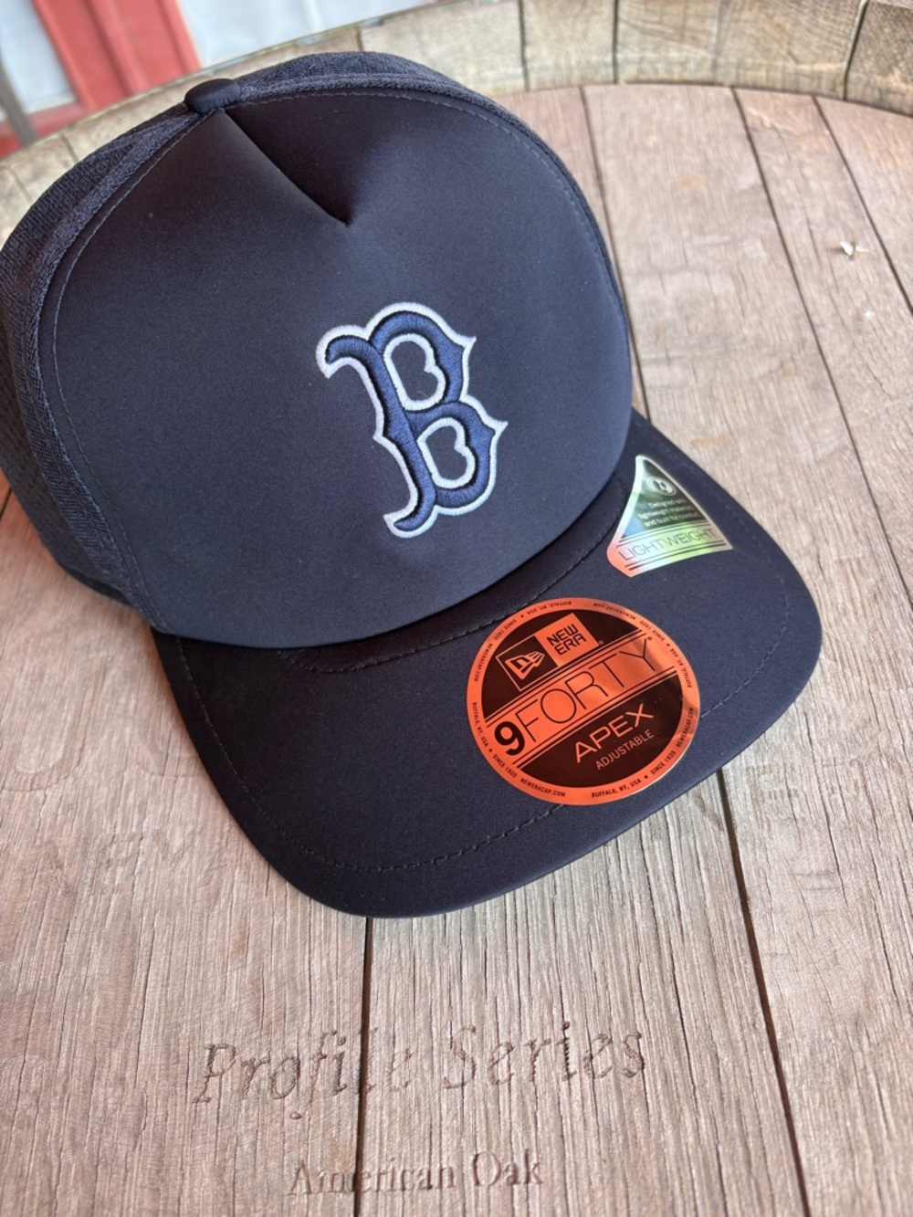 New Era navy trucker cap with white-outlined 'B' logo